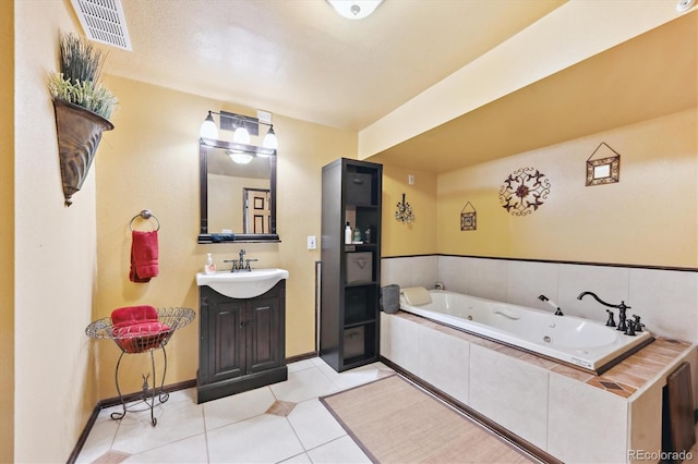 bathroom featuring vanity, baseboards, visible vents, tile patterned floors, and a jetted tub