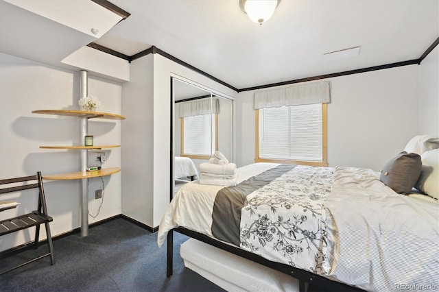 bedroom with dark colored carpet, a closet, baseboards, and crown molding