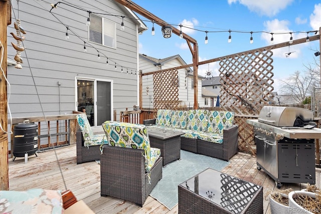 wooden deck featuring a grill and outdoor lounge area