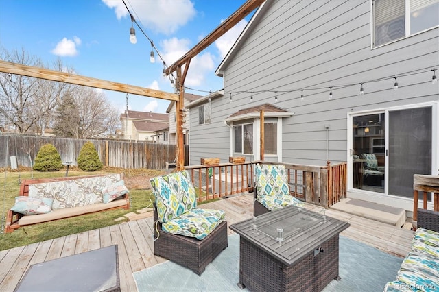 wooden deck with outdoor lounge area and fence