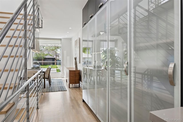 interior space featuring recessed lighting, light wood finished floors, and stairs