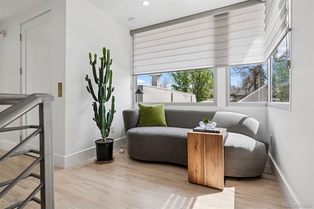 sitting room with baseboards, recessed lighting, and wood finished floors