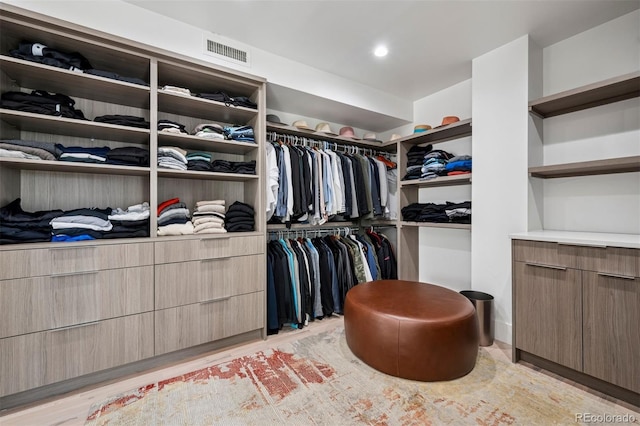 walk in closet featuring light wood-type flooring and visible vents