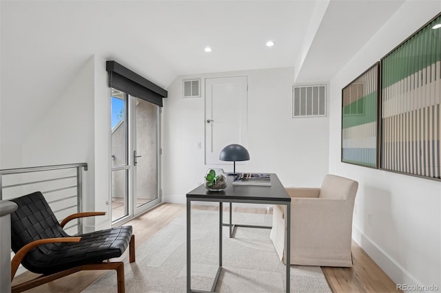 home office featuring baseboards, wood finished floors, and visible vents