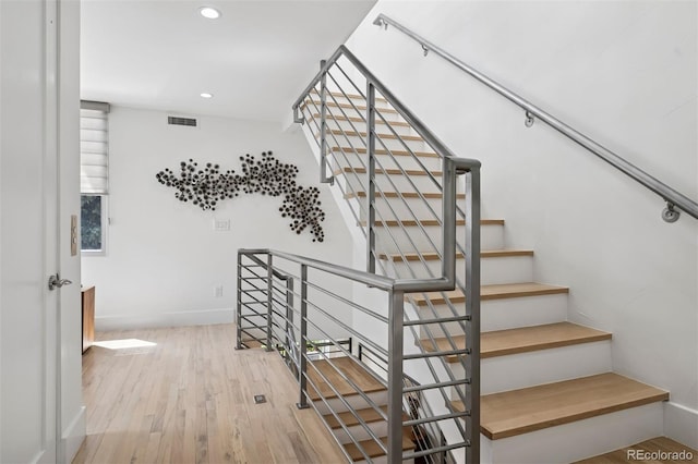 stairs featuring baseboards, recessed lighting, wood finished floors, and visible vents