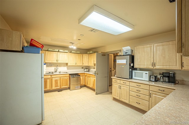 kitchen with sink, light brown cabinets, white appliances, and light tile patterned floors