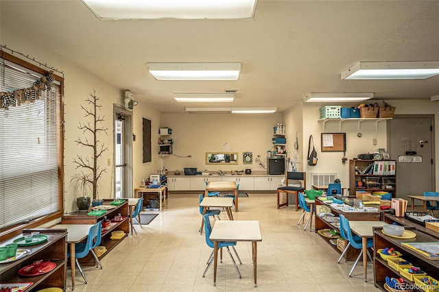 misc room with light tile patterned flooring and a wealth of natural light