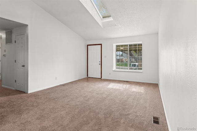 12116 N Fairfax St, Thornton, CO 80241 - carpeted empty room with baseboards, lofted ceiling with skylight, visible vents, and a textured ceiling
