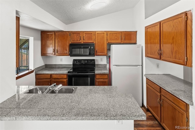 12116 N Fairfax St, Thornton, CO 80241 - kitchen featuring lofted ceiling, tile countertops, a sink, brown cabinets, and black appliances