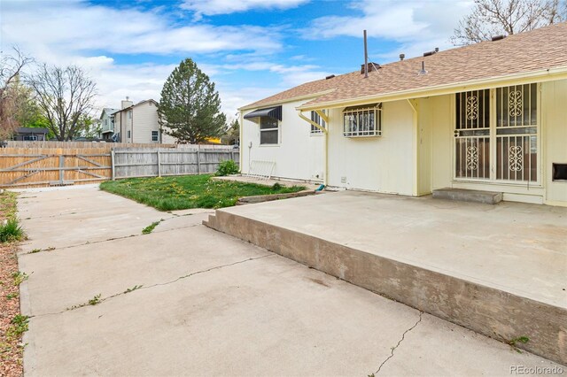 12116 N Fairfax St, Thornton, CO 80241 - back of property with fence, a patio, and a shingled roof