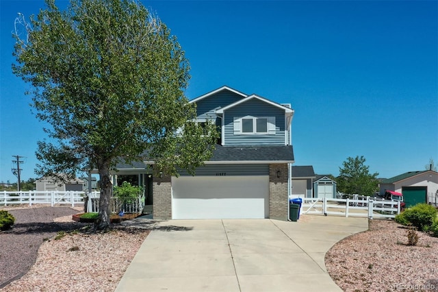11577 Cranston Dr, Peyton, CO 80831 - view of front of property with brick siding, an attached garage, driveway, and a gate