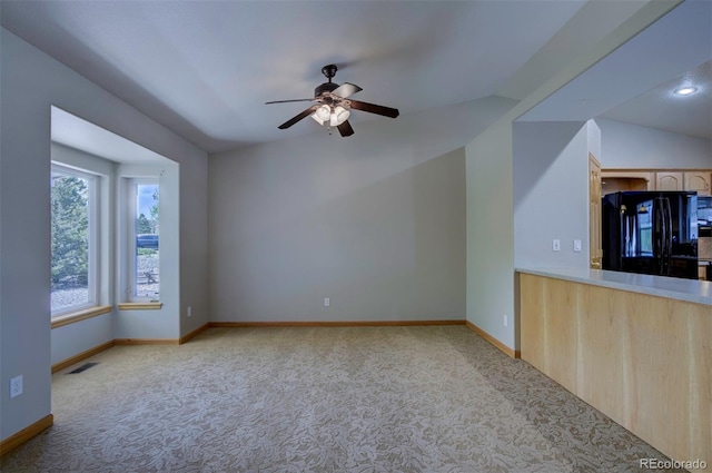 11577 Cranston Dr, Peyton, CO 80831 - unfurnished living room with carpet floors, a ceiling fan, baseboards, and lofted ceiling