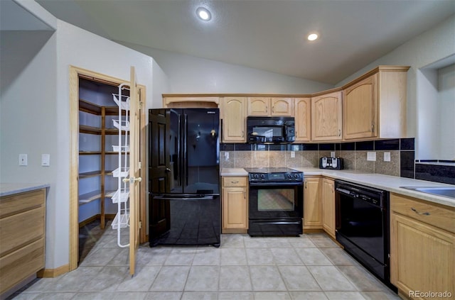 11577 Cranston Dr, Peyton, CO 80831 - kitchen with black appliances, backsplash, vaulted ceiling, light brown cabinetry, and light countertops