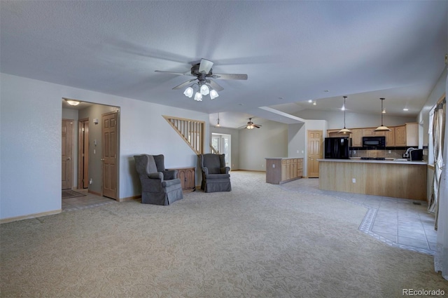 11577 Cranston Dr, Peyton, CO 80831 - unfurnished living room with ceiling fan, light carpet, vaulted ceiling, a sink, and baseboards