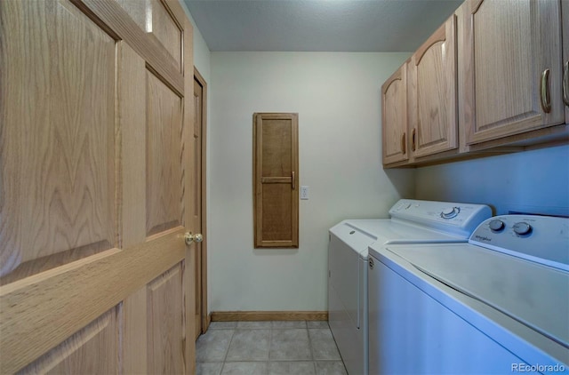 11577 Cranston Dr, Peyton, CO 80831 - washroom featuring cabinet space, separate washer and dryer, baseboards, and light tile patterned floors