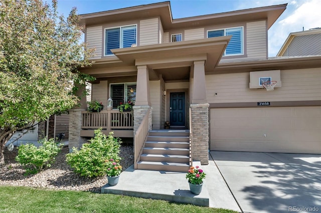 21658 E Tallkid Ave, Parker, CO 80138 - view of front of home with concrete driveway, an attached garage, and a porch