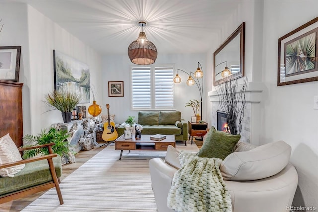 21658 E Tallkid Ave, Parker, CO 80138 - living area featuring a glass covered fireplace and wood finished floors