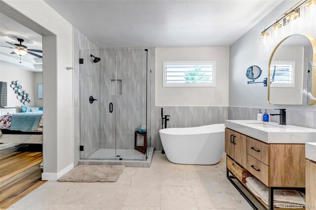 21658 E Tallkid Ave, Parker, CO 80138 - full bathroom with ensuite bath, vanity, a shower stall, ceiling fan, and a freestanding tub