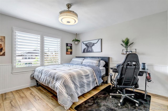 21658 E Tallkid Ave, Parker, CO 80138 - bedroom with a wainscoted wall and light wood finished floors