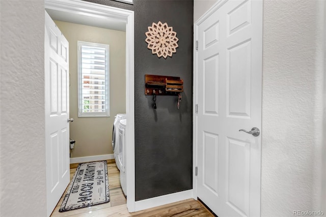 21658 E Tallkid Ave, Parker, CO 80138 - washroom with washing machine and dryer, a textured wall, and light wood-style floors