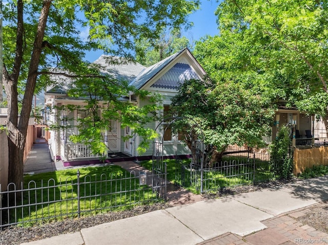 2323 W Pikes Peak Ave, Colorado Springs, CO 80904 - victorian-style house featuring a fenced front yard and covered porch