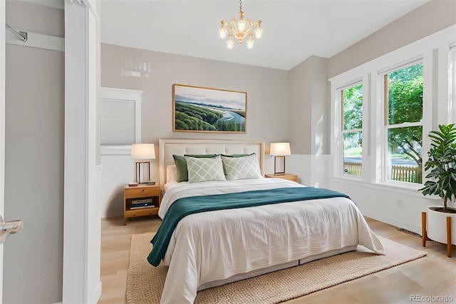 2323 W Pikes Peak Ave, Colorado Springs, CO 80904 - bedroom featuring light wood-style floors and a chandelier