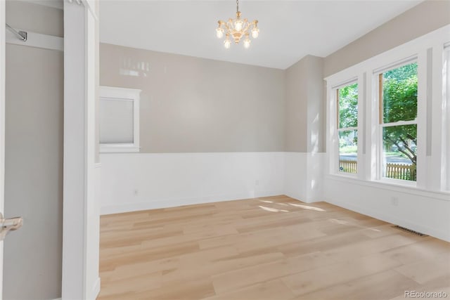 2323 W Pikes Peak Ave, Colorado Springs, CO 80904 - empty room with light wood-style flooring and a chandelier