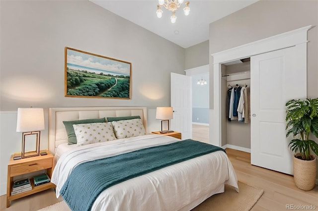 2323 W Pikes Peak Ave, Colorado Springs, CO 80904 - bedroom with a chandelier, light wood-style flooring, and a closet