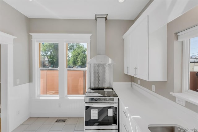 2323 W Pikes Peak Ave, Colorado Springs, CO 80904 - kitchen featuring stainless steel electric stove, healthy amount of natural light, and white cabinetry