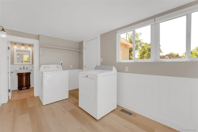 2323 W Pikes Peak Ave, Colorado Springs, CO 80904 - laundry area featuring washer and dryer and light wood-style floors