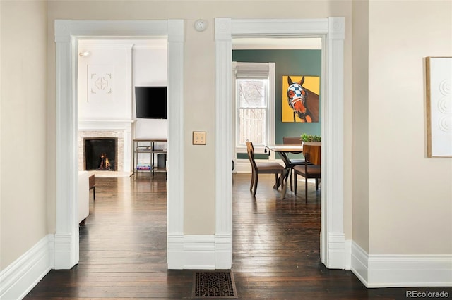 corridor with dark wood-style flooring