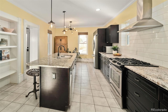 kitchen featuring stainless steel appliances, a sink, a kitchen breakfast bar, ornamental molding, and wall chimney range hood