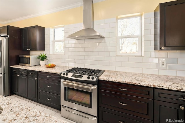 kitchen with extractor fan, light tile patterned flooring, ornamental molding, appliances with stainless steel finishes, and decorative backsplash