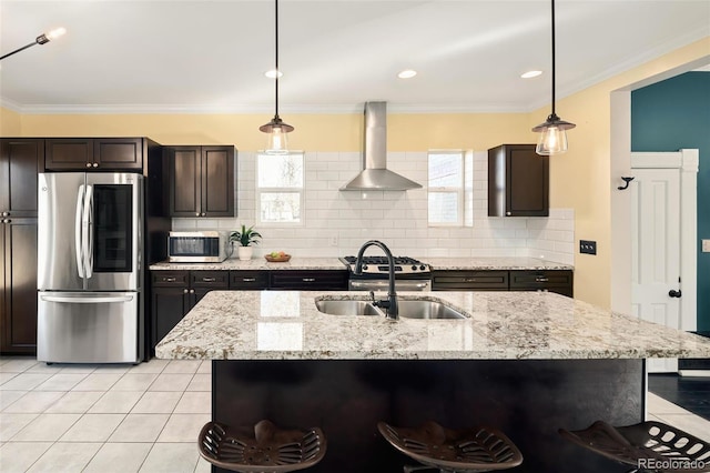 kitchen with a sink, appliances with stainless steel finishes, wall chimney exhaust hood, tasteful backsplash, and crown molding