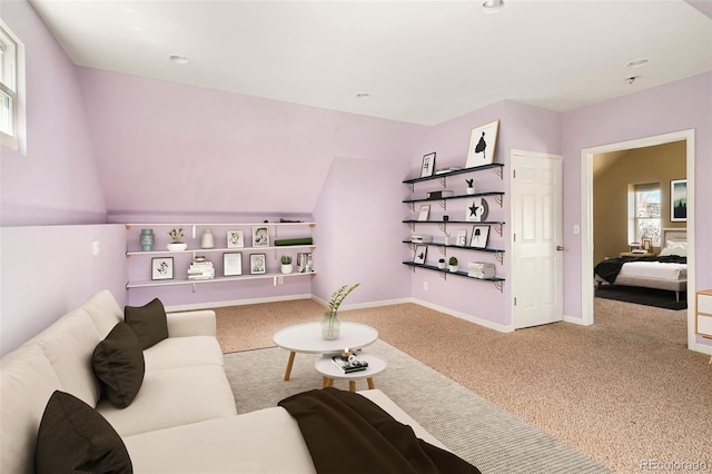 living room featuring carpet and baseboards