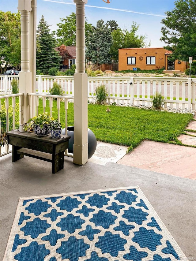 view of patio / terrace featuring covered porch and fence