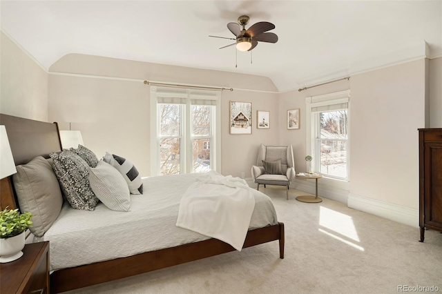 bedroom featuring lofted ceiling, ceiling fan, baseboards, and light colored carpet