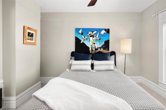 carpeted bedroom featuring ceiling fan and baseboards