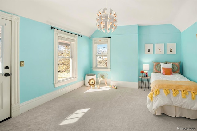 carpeted bedroom with lofted ceiling, an inviting chandelier, and baseboards