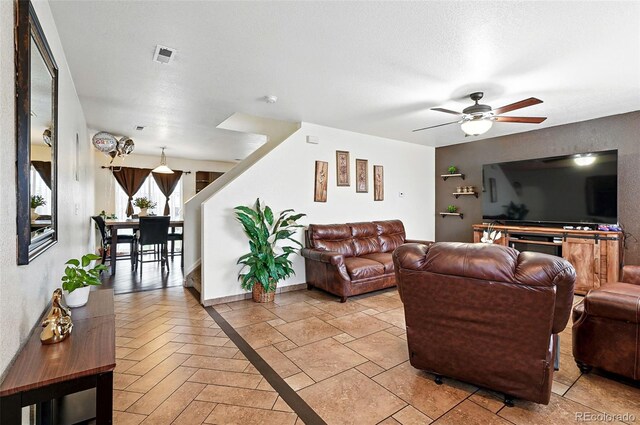 1419 Swan Ave, Brighton, CO 80601 - living room with a ceiling fan, stairs, and baseboards