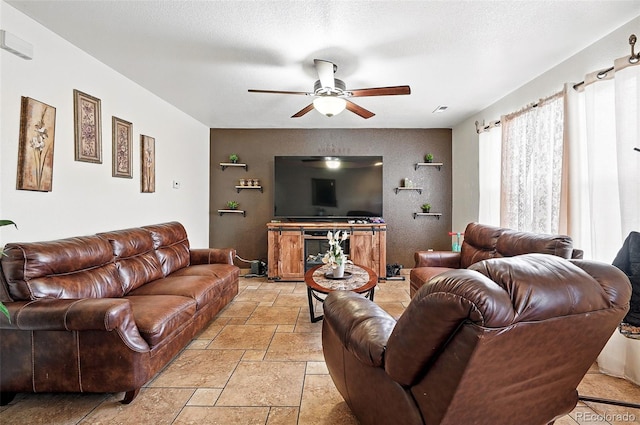 1419 Swan Ave, Brighton, CO 80601 - living area with stone tile floors, a ceiling fan, and an accent wall