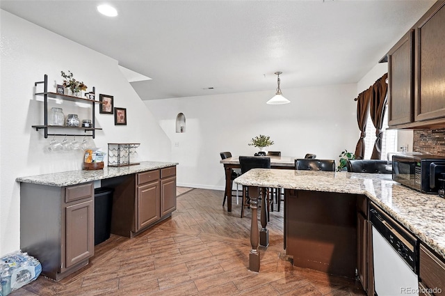 1419 Swan Ave, Brighton, CO 80601 - kitchen featuring black microwave, light wood-style flooring, a peninsula, light stone countertops, and recessed lighting