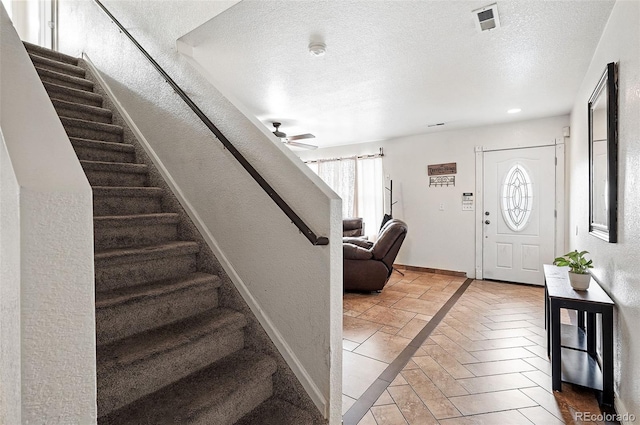 1419 Swan Ave, Brighton, CO 80601 - entryway featuring baseboards, stairway, a ceiling fan, a textured wall, and a textured ceiling