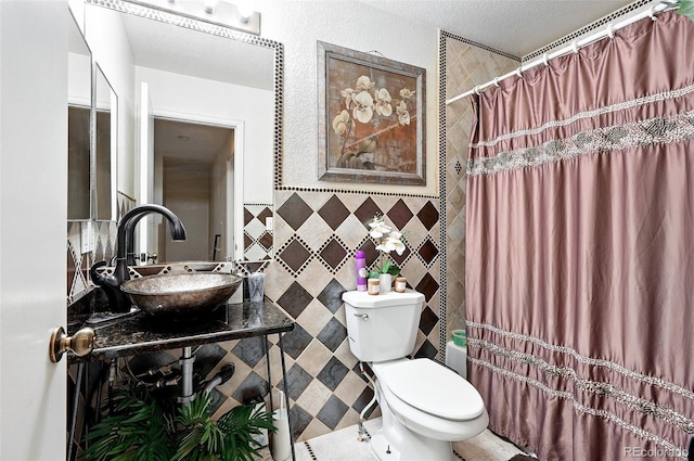 1419 Swan Ave, Brighton, CO 80601 - bathroom with a sink, tile walls, toilet, and shower / tub combo