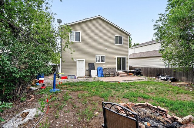 1419 Swan Ave, Brighton, CO 80601 - back of house with a patio area, a fenced backyard, and entry steps