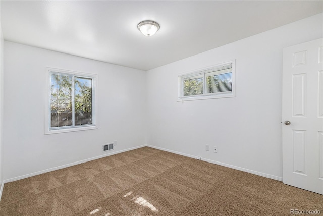 carpeted empty room featuring plenty of natural light