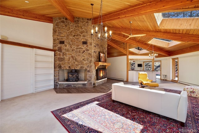 1000 Ponderosa Way, Woodland Park, CO 80863 - carpeted living area featuring a chandelier, a fireplace, a wooden ceiling with exposed beams, a baseboard heating unit, and a skylight
