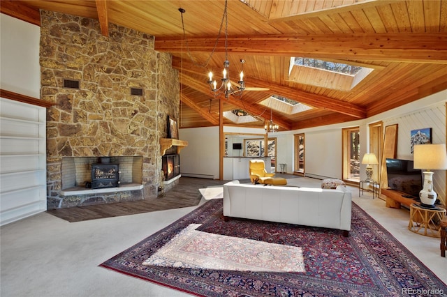 1000 Ponderosa Way, Woodland Park, CO 80863 - carpeted living room with a chandelier, wooden ceiling, a skylight, a baseboard radiator, and a stone fireplace