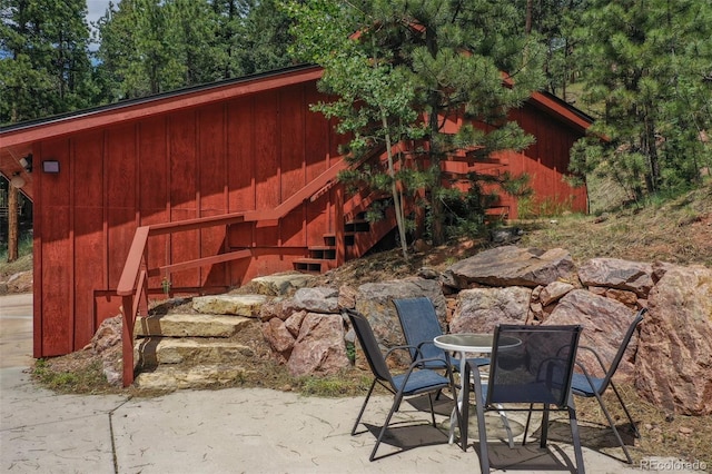 1000 Ponderosa Way, Woodland Park, CO 80863 - view of patio featuring stairs and outdoor dining space