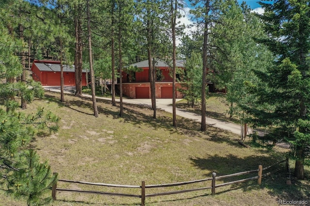 1000 Ponderosa Way, Woodland Park, CO 80863 - view of yard featuring an outbuilding, an attached garage, and driveway